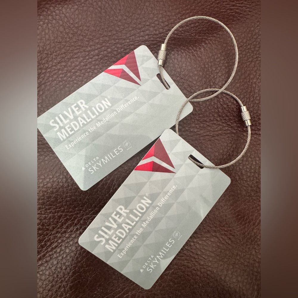 Delta Silver Medallion Tags with Red Accents. Firm price.